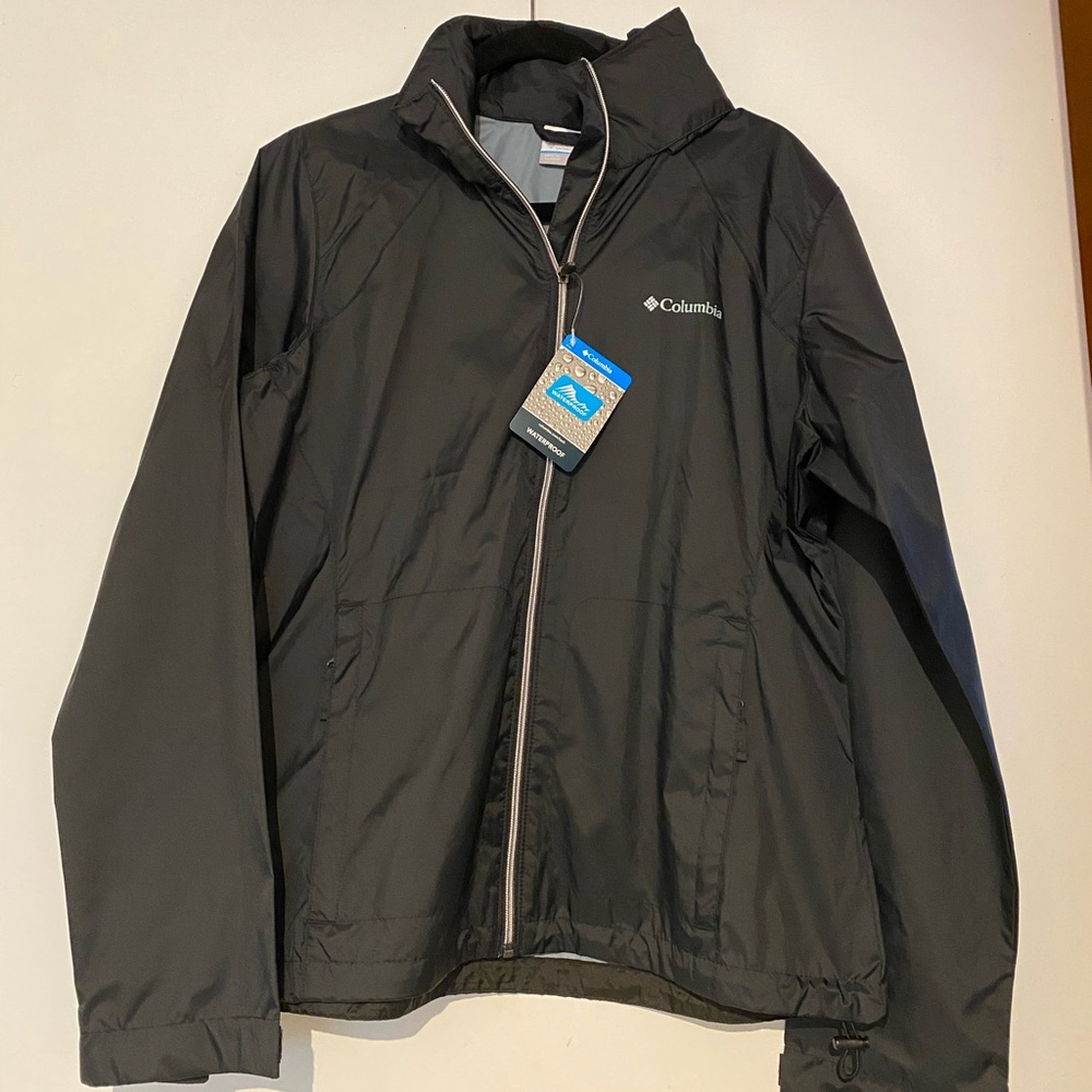 Tags on. Columbia showerproof light jacket hood in collar. Perfect for travel